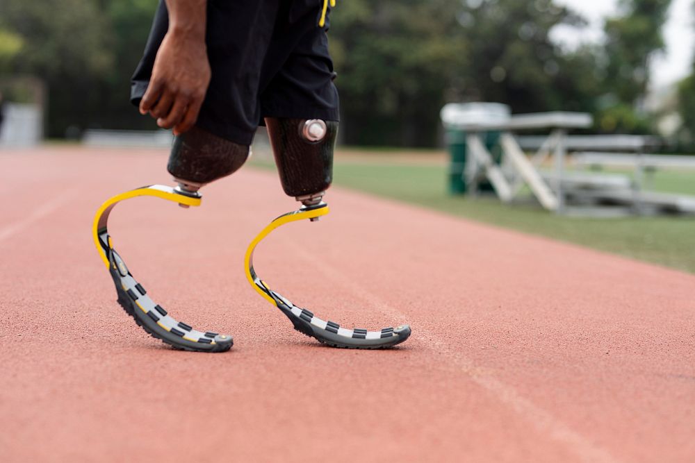 Athlete with prosthetic legs on a running track 