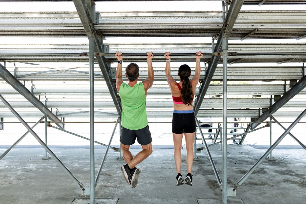 Man and woman fitness trainers using a cable machine 