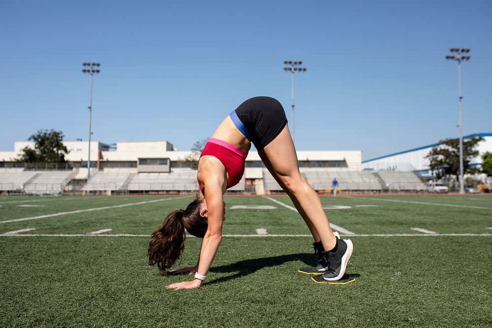 Woman athlete in a downward dog position