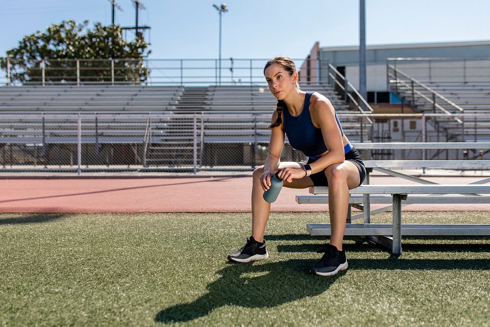 Athletic woman resing by the bench 