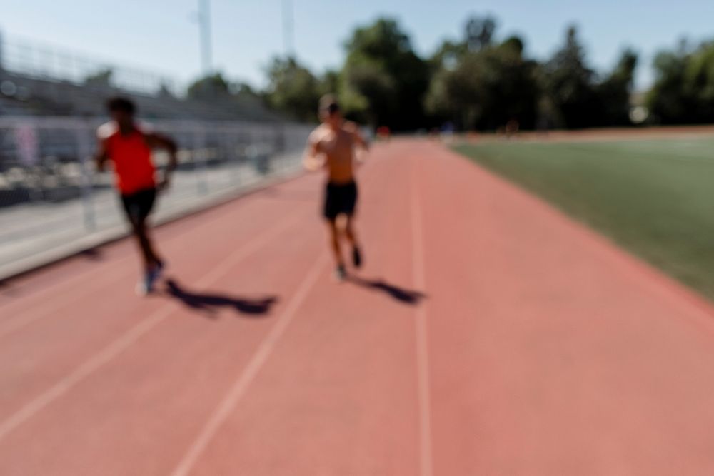 Blurry image of runners on a track 