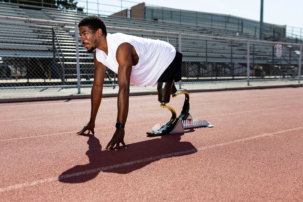 Paralympic sprinter with prosthetic legs started racing from a starting block 
