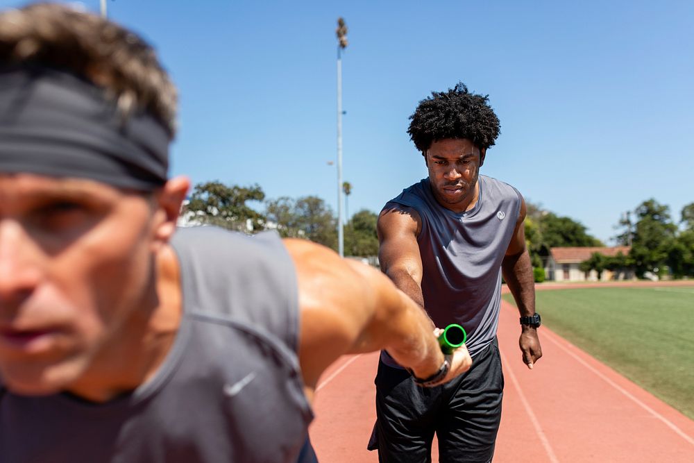 Team mates passing a relay baton