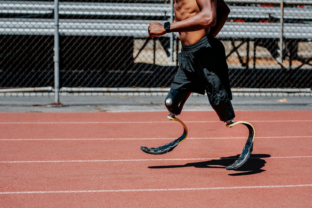 Man paralympic athlete running with prosthetic legs