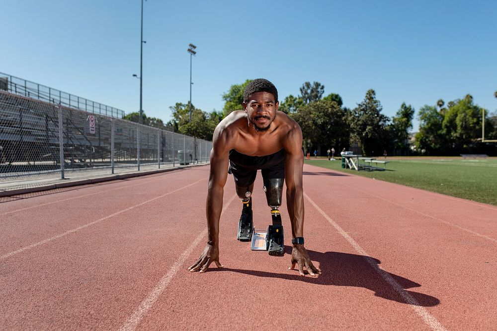 Paralympic sprinter with prosthetic blades started racing from a starting block 