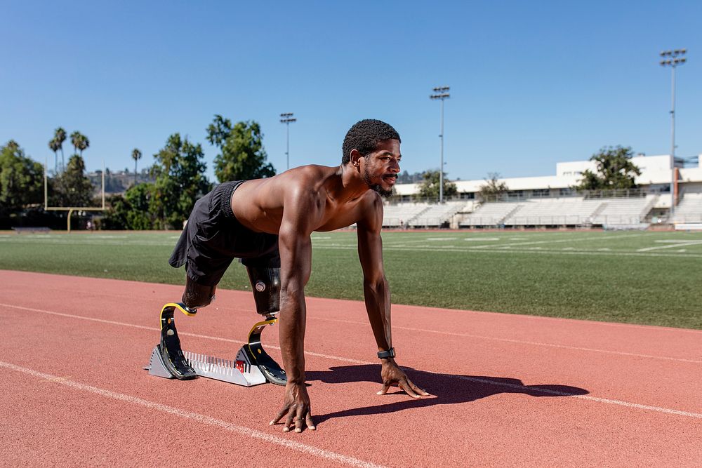 Paralympic sprinter with prosthetic blades started racing from a starting block 