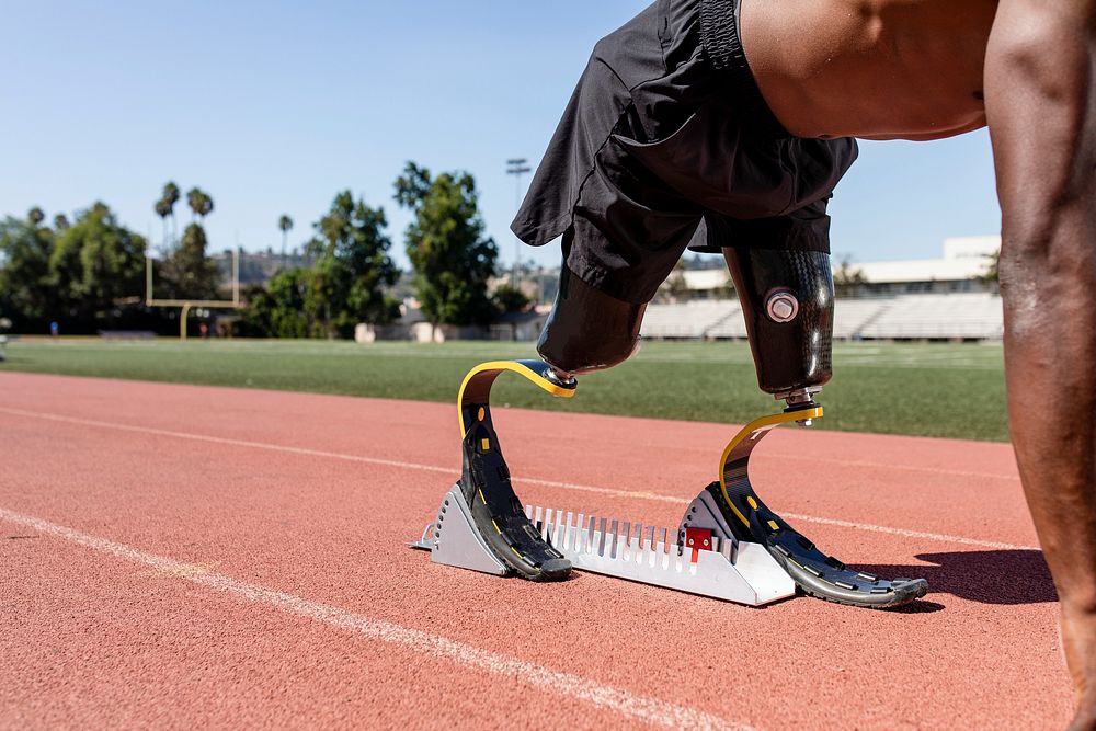 Paralympic sprinter with prosthetic blades started racing from a starting block 