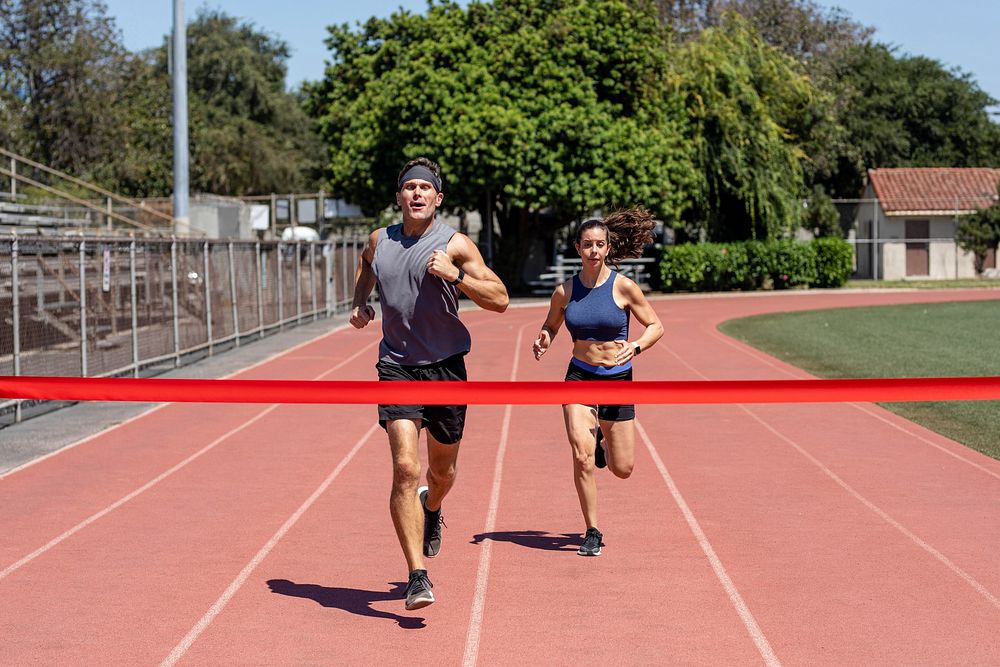 Man and woman runners competing, athletic race competition