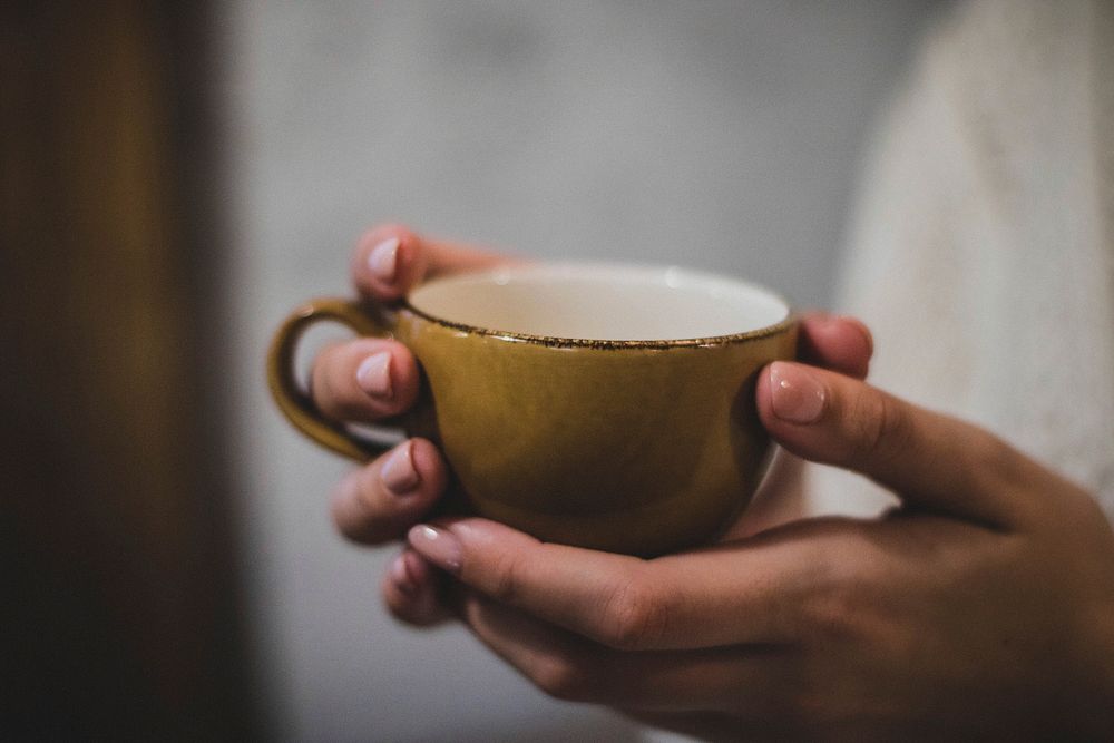 Free hands holding a cup of coffee photo, public domain drink CC0 image.