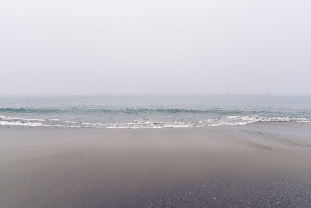 Sandy shore, clear sky, beach, ocean waves, free public domain CC0 photo.