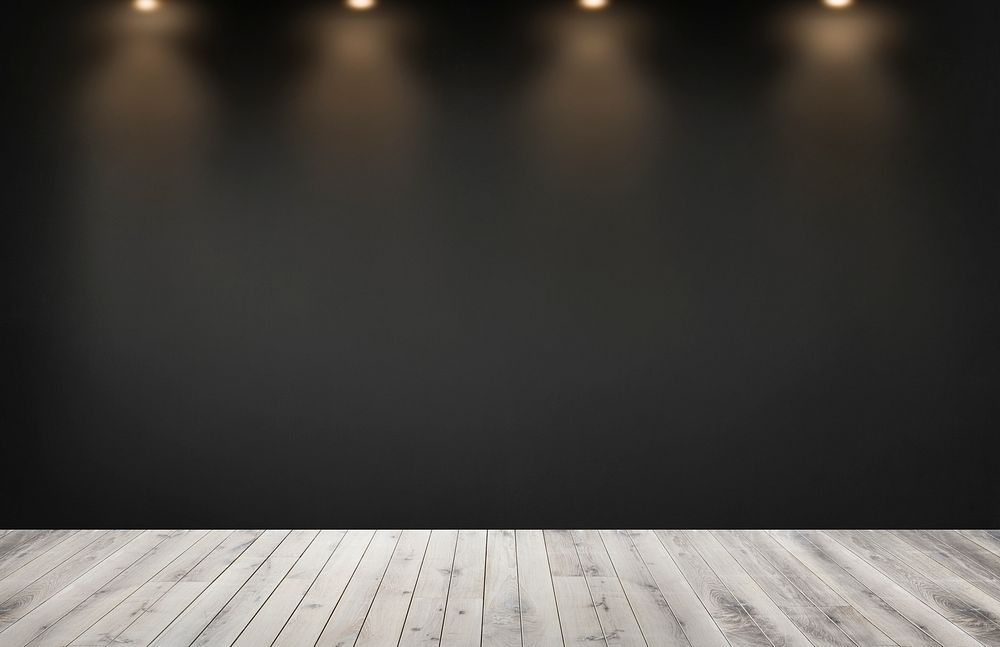 Black wall with a row of spotlights in an empty room