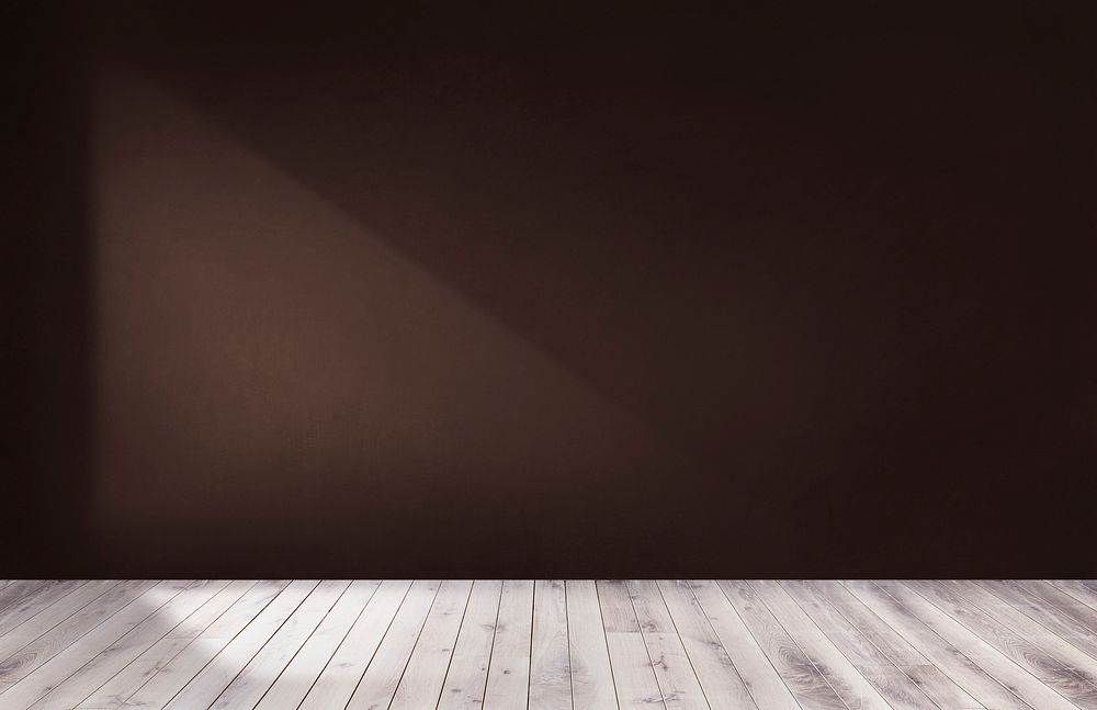 Dark brown wall in an empty room with a wooden floor