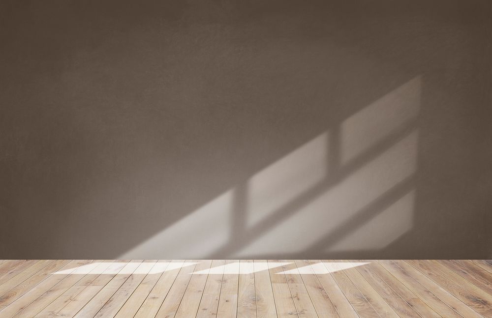 Brown wall in an empty room with a wooden floor