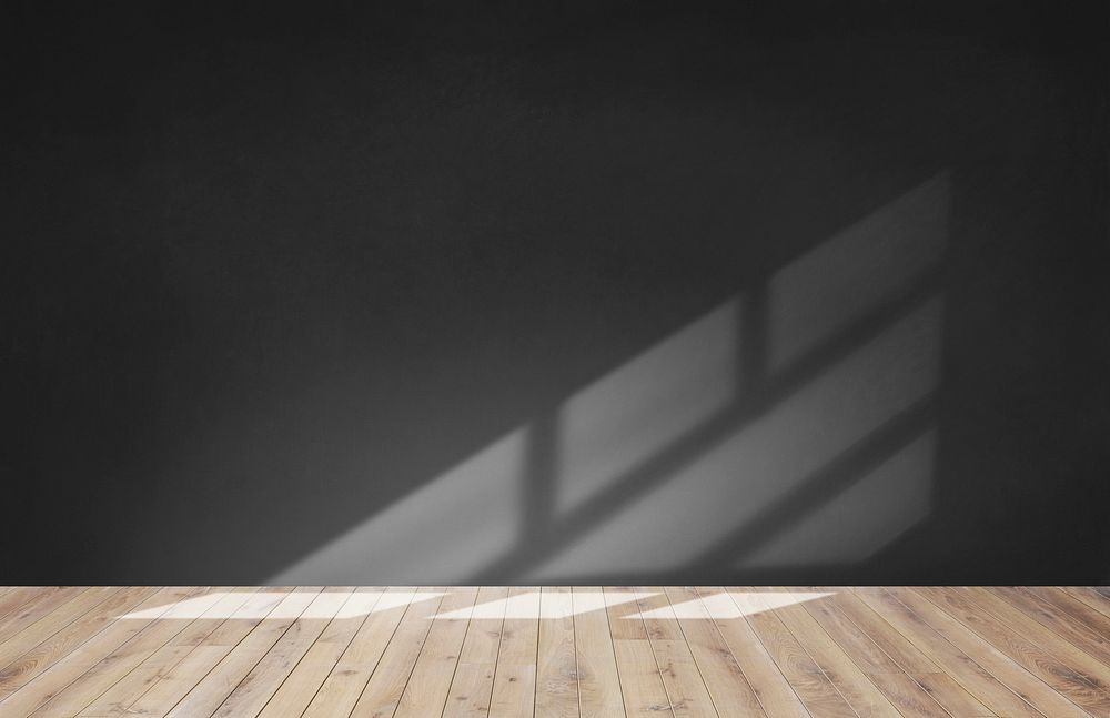 Black wall in an empty room with wooden floor