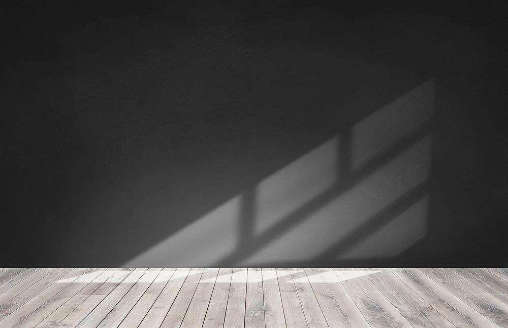 Black wall in an empty room with wooden floor