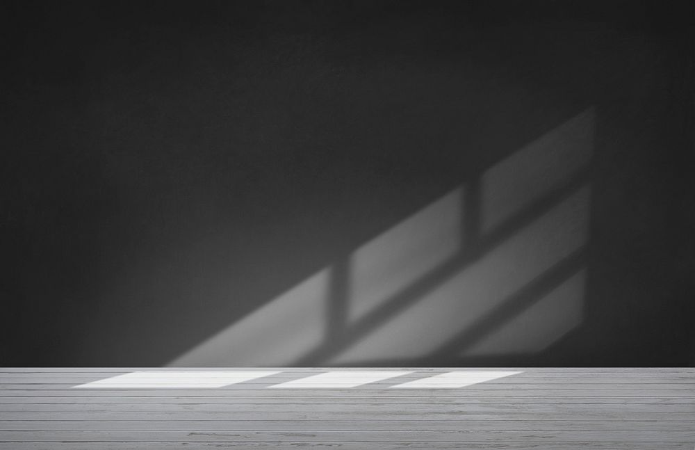 Black wall in an empty room with concrete floor
