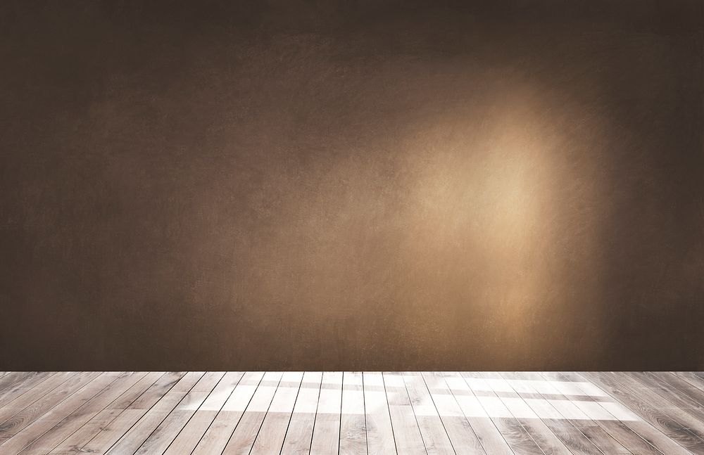 Brown wall in an empty room with a wooden floor