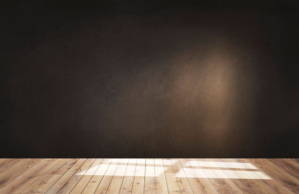 Dark brown wall in an empty room with a wooden floor