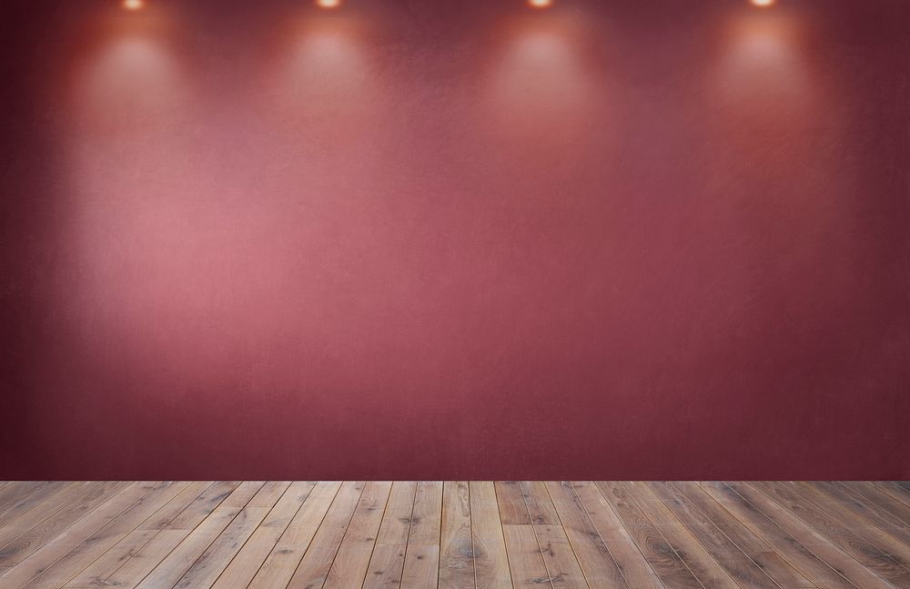 Red wall with a row of spotlights in an empty room