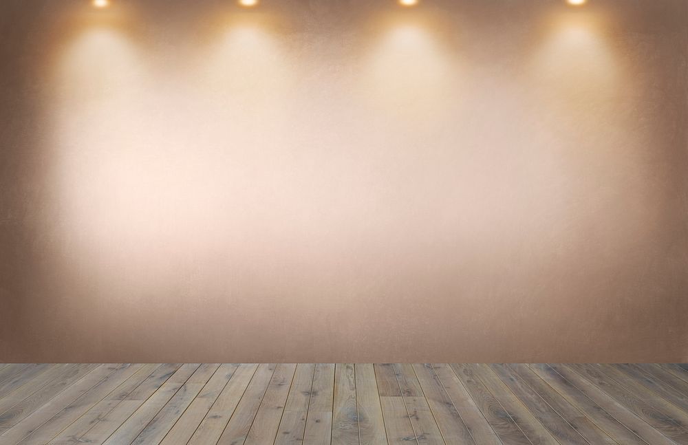 Faded orange wall with a row of spotlights in an empty room
