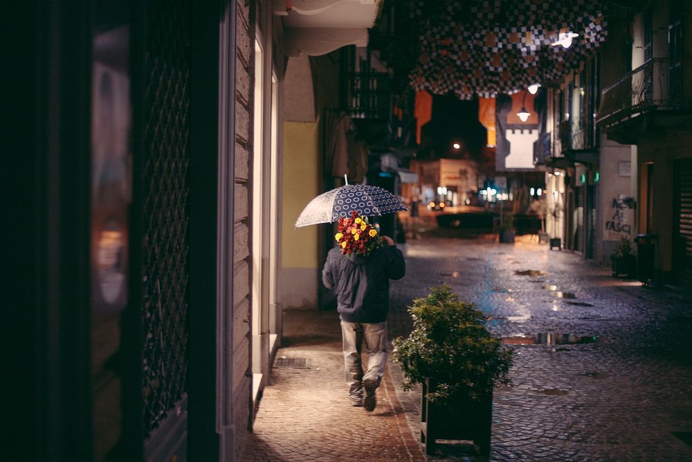 Free man with umbrella & flower walking alone image, public domain human CC0 photo.