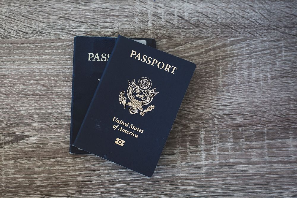 Free passports on wooden table photo, public domain CC0 image.
