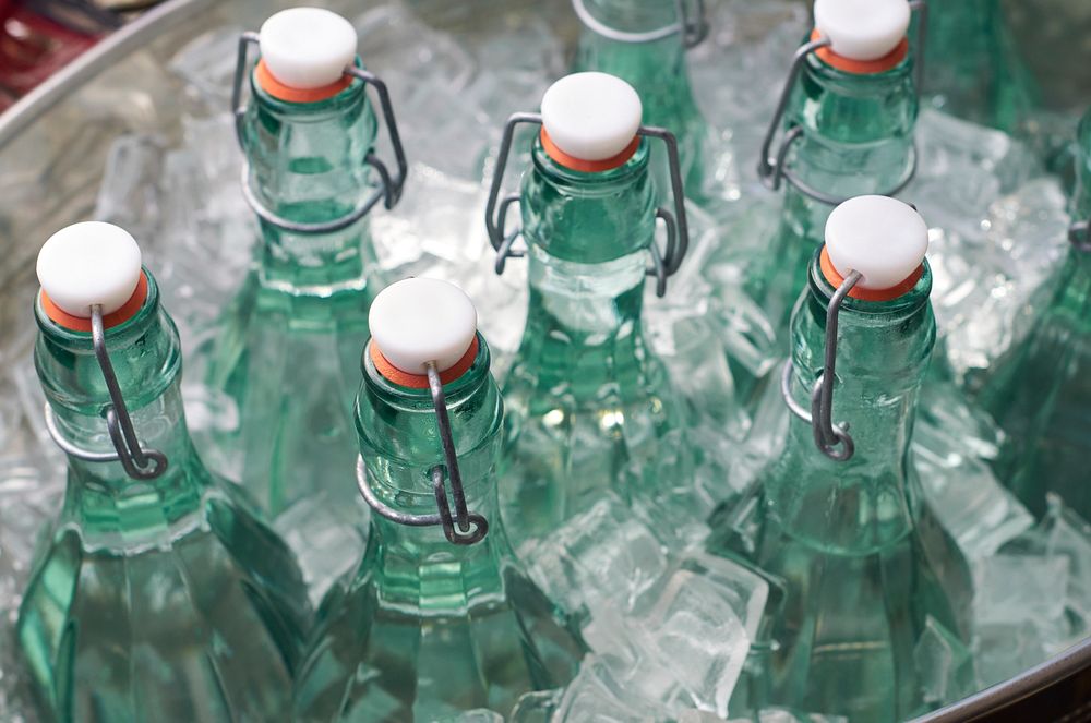 Free glass bottles in ice bucket public domain CC0 photo.