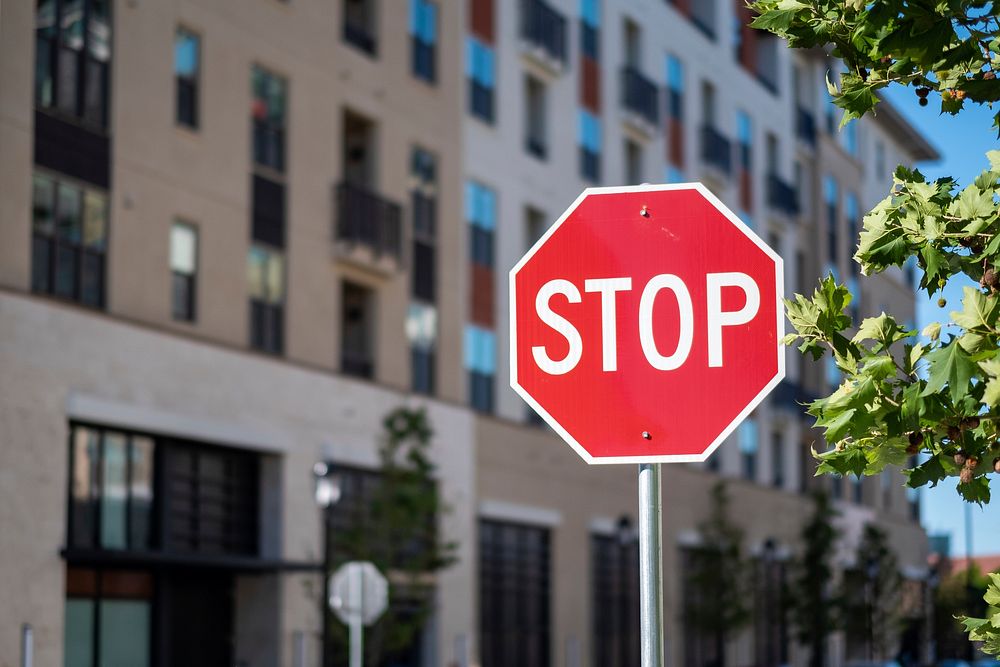 Free stop sign in a city image, public domain CC0 photo.