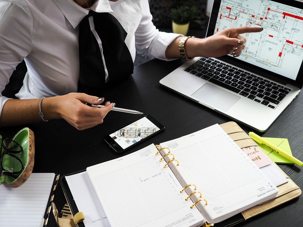 Free business woman with laptop and plans image, public domain CC0 photo.