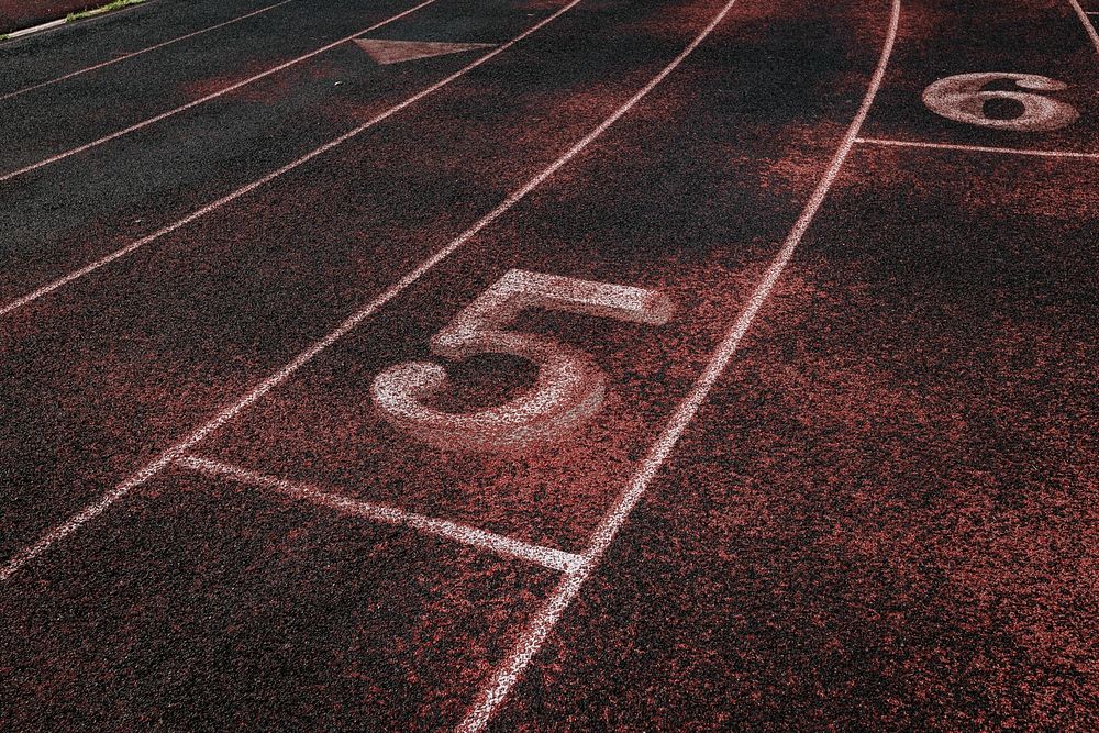 Free close up texture of running track surface with numbers photo, public domain sport CC0 image.