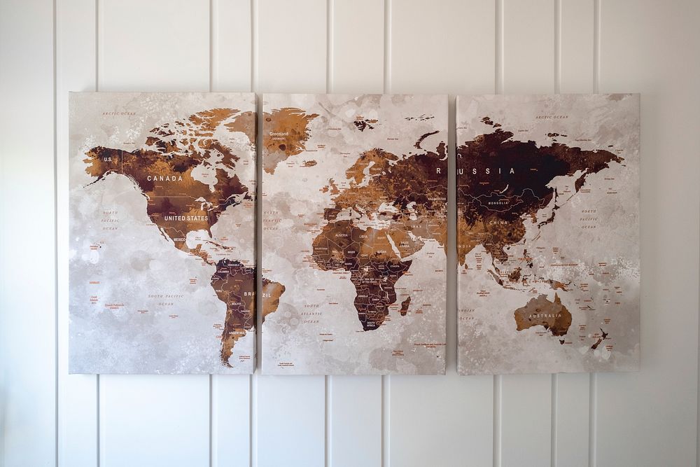 Free world map poster hanging on the wall public domain CC0 photo.