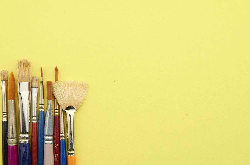 Paint brushes with yellow background, free public domain CC0 photo