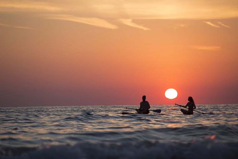 Free couple kayaking in the sea at sunset image, public domain CC0 photo.