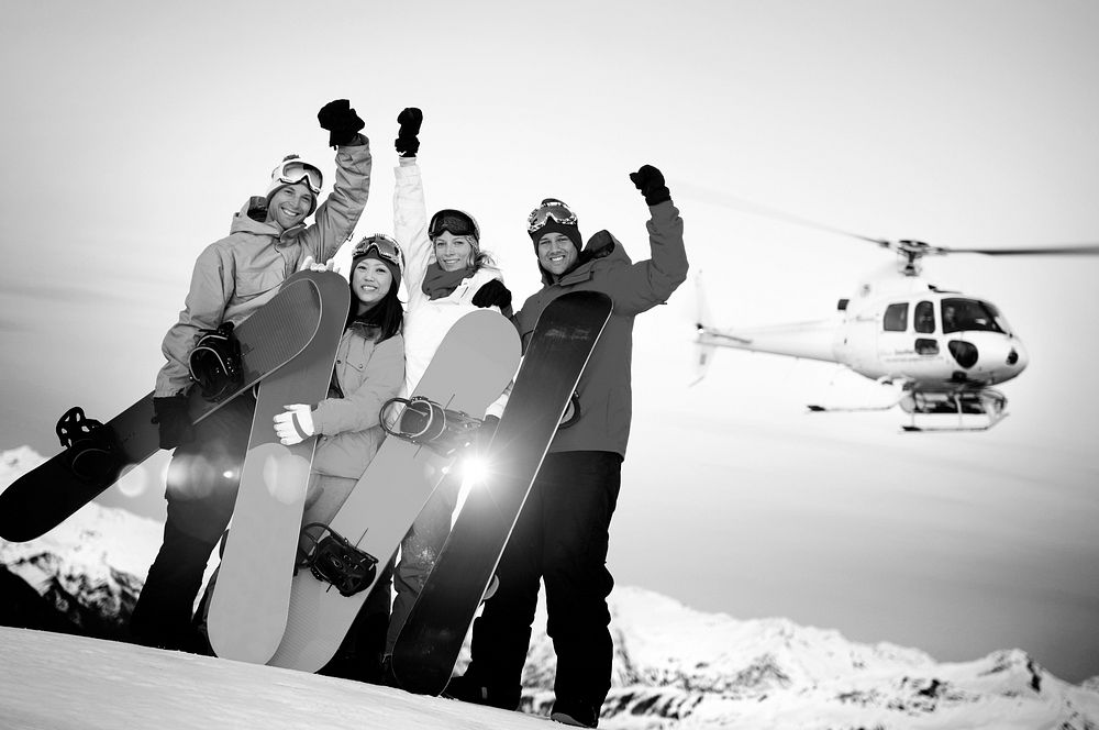 Snowboarders on top of the Mountain with Heli Ski
