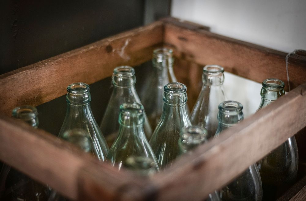 Free empty glass bottle in wooden crate public domain CC0 photo.