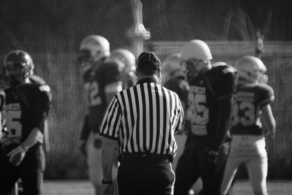 Free american football referee during game photo, public domain sport CC0 image.