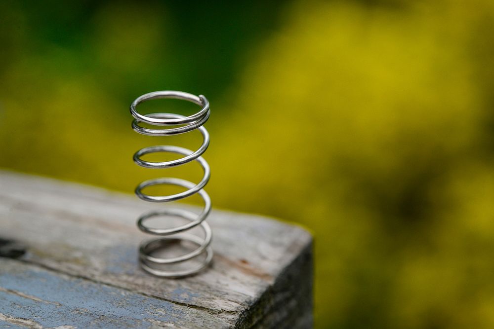 Free metal coil spring on a table image, public domain CC0 photo.