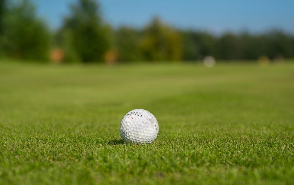 Free close up on golf ball on green grass photo, public domain sport CC0 image.