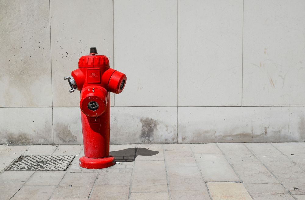 Free red fire hydrant on ground photo, public domain CC0 image.