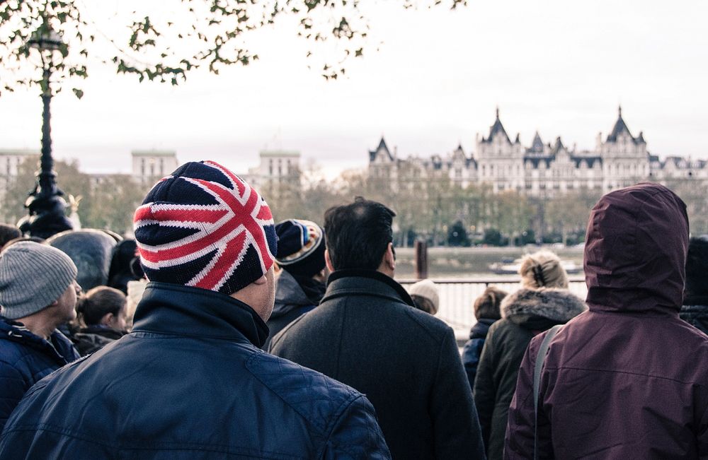 Free Man wearing union jack cap in London image, public domain travel CC0 photo.