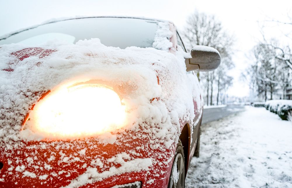Car headlights covering with snow photo, free public domain CC0 image.