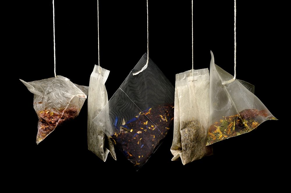 Free tea bags hanging on black background public domain CC0 photo