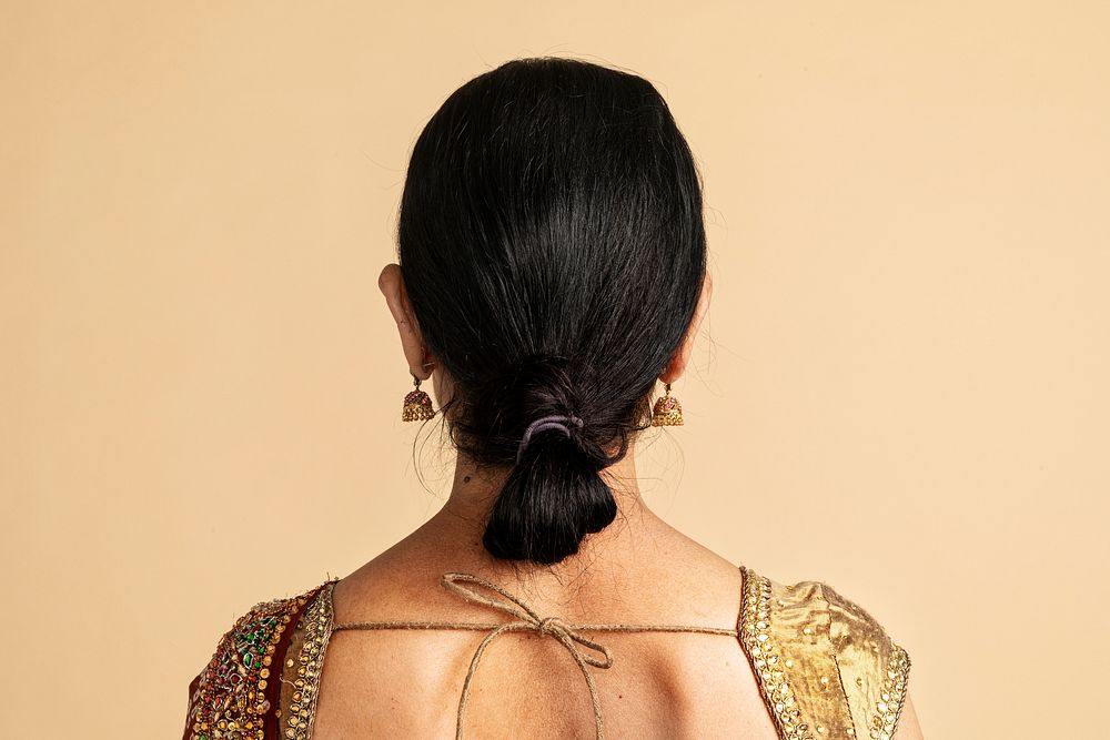 Rear view of an Indian woman in a traditional saree