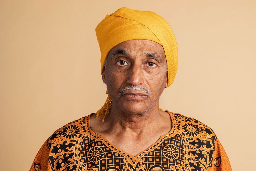 Mixed senior Indian man wearing a yellow turban