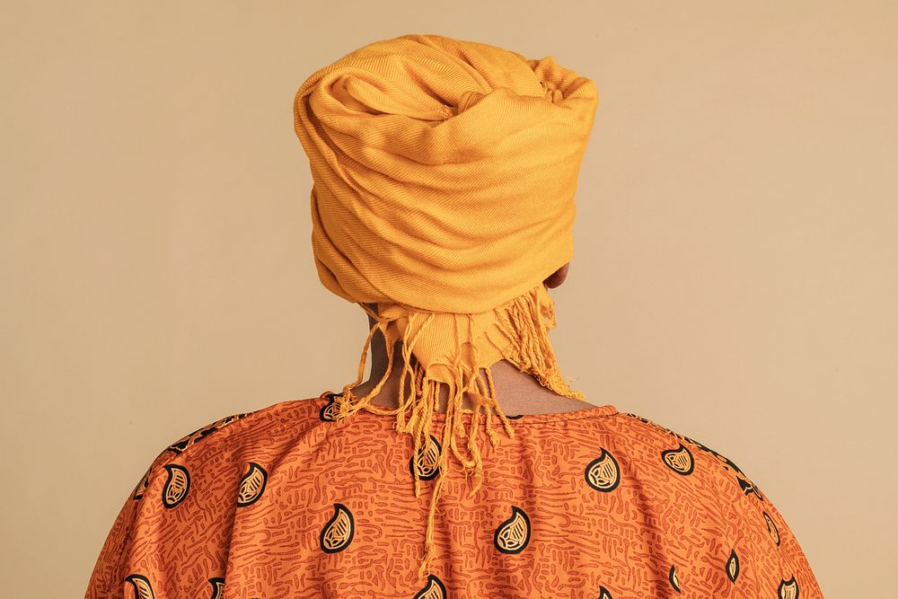 Back view of an Indian man wearing a yellow turban