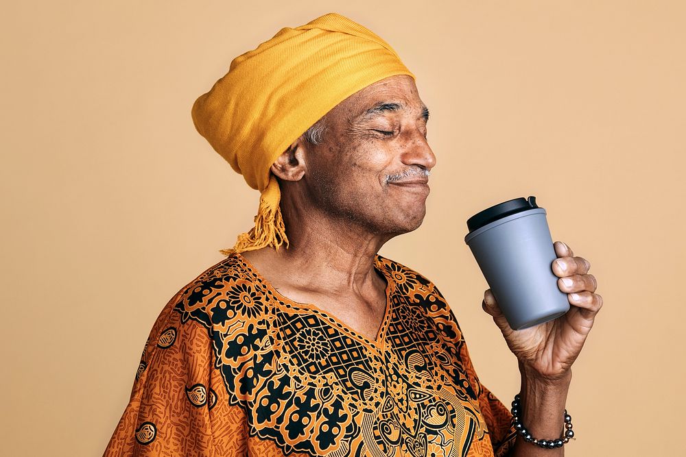 Senior mixed Indian man drinking coffee from a tumbler mockup 