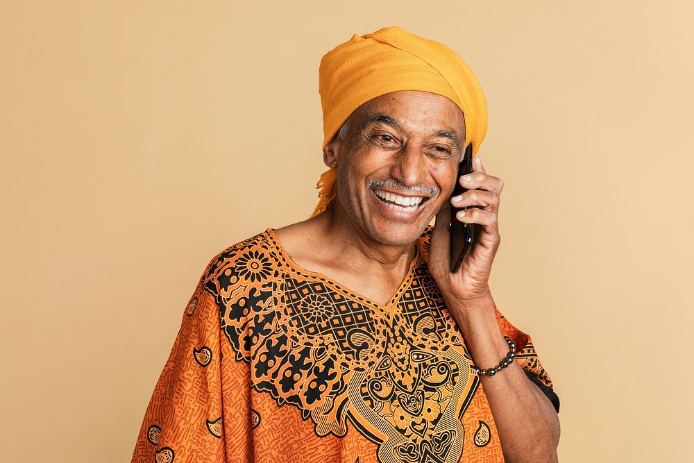 Senior mixed Indian man talking on the phone 