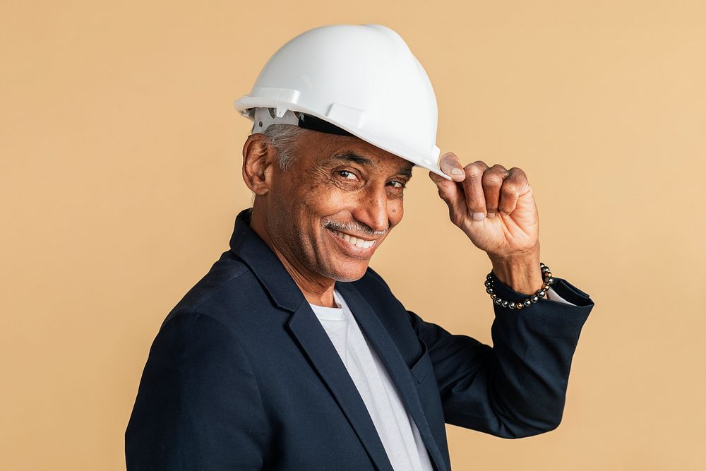 Mixed Indian engineer wearing a helmet for protection 