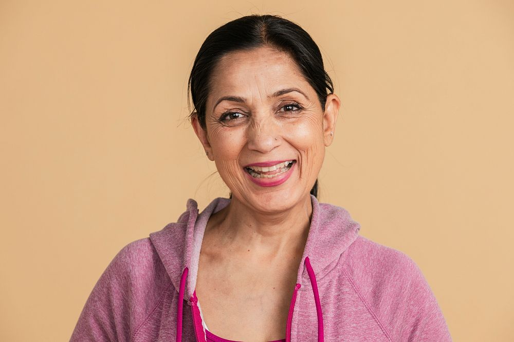 Happy Indian woman in a pink hoodie 