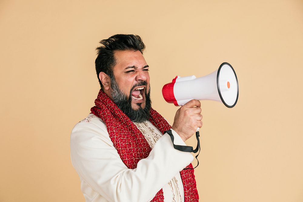Indian man screaming into a megaphone 